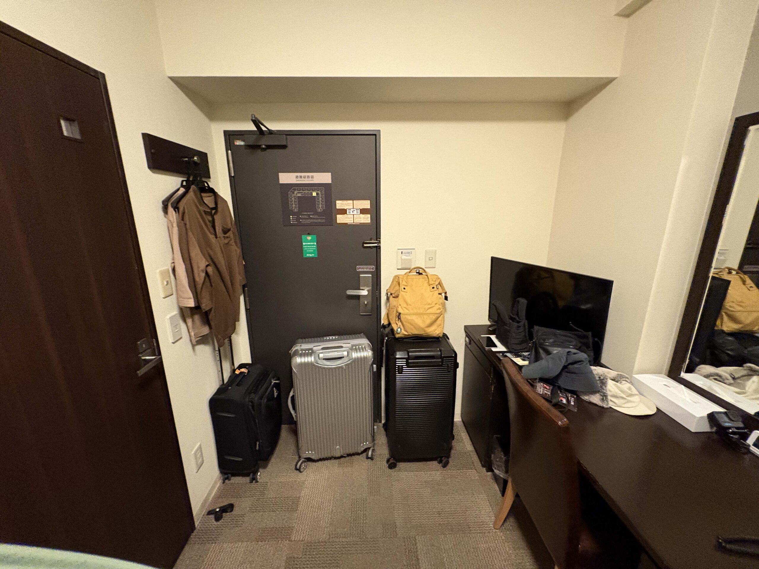 房間並不大，但該有的設備（桌椅、電視、小冰箱）都有